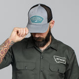 Trucker hat, snap back, gray/blue. Free 5" logo sticker included.